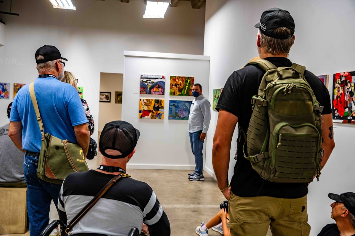 Attendees in discussion at the gallery